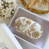 Ivory clutch bag with gold floral embroidery