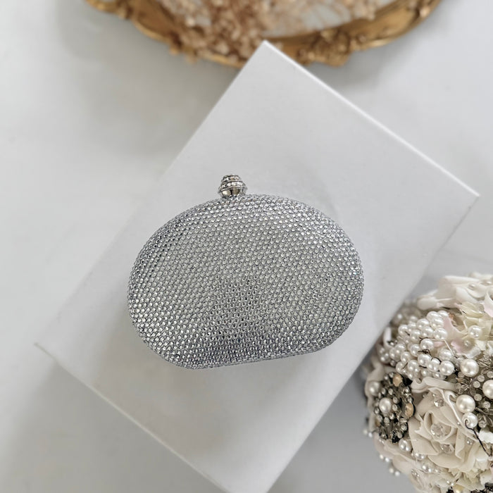 A silver rhinestone-embellished oval evening clutch purse m