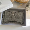 A silver rhinestone-embellished clutch purse