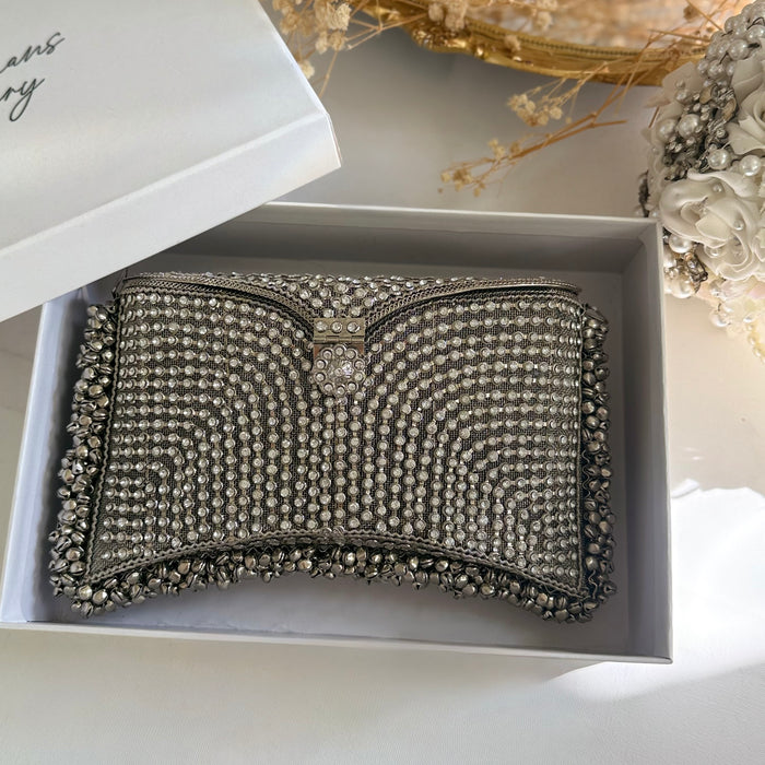 A silver rhinestone-embellished clutch purse