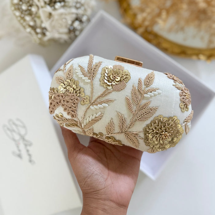 Ivory clutch bag with gold floral embroidery