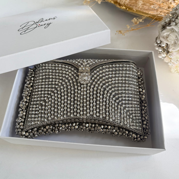 A silver rhinestone-embellished clutch purse