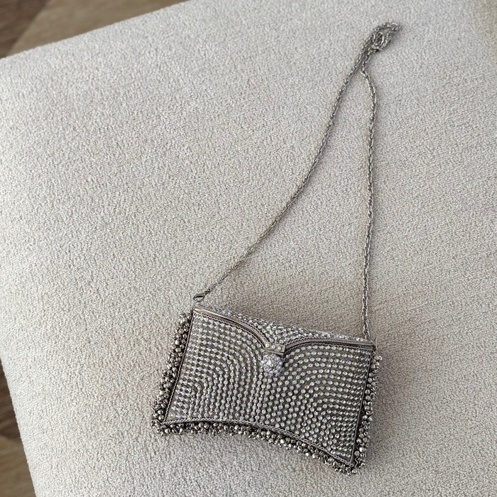 A silver rhinestone-embellished clutch purse