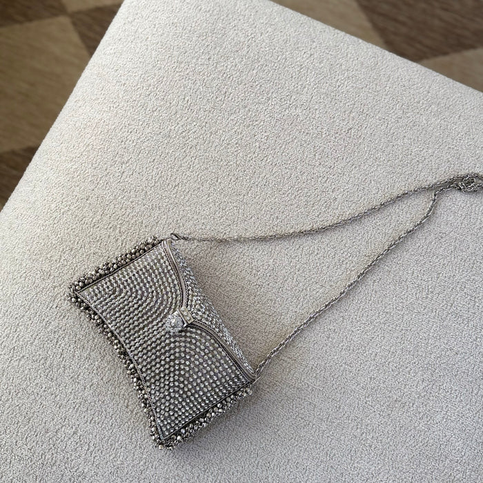 A silver rhinestone-embellished clutch purse